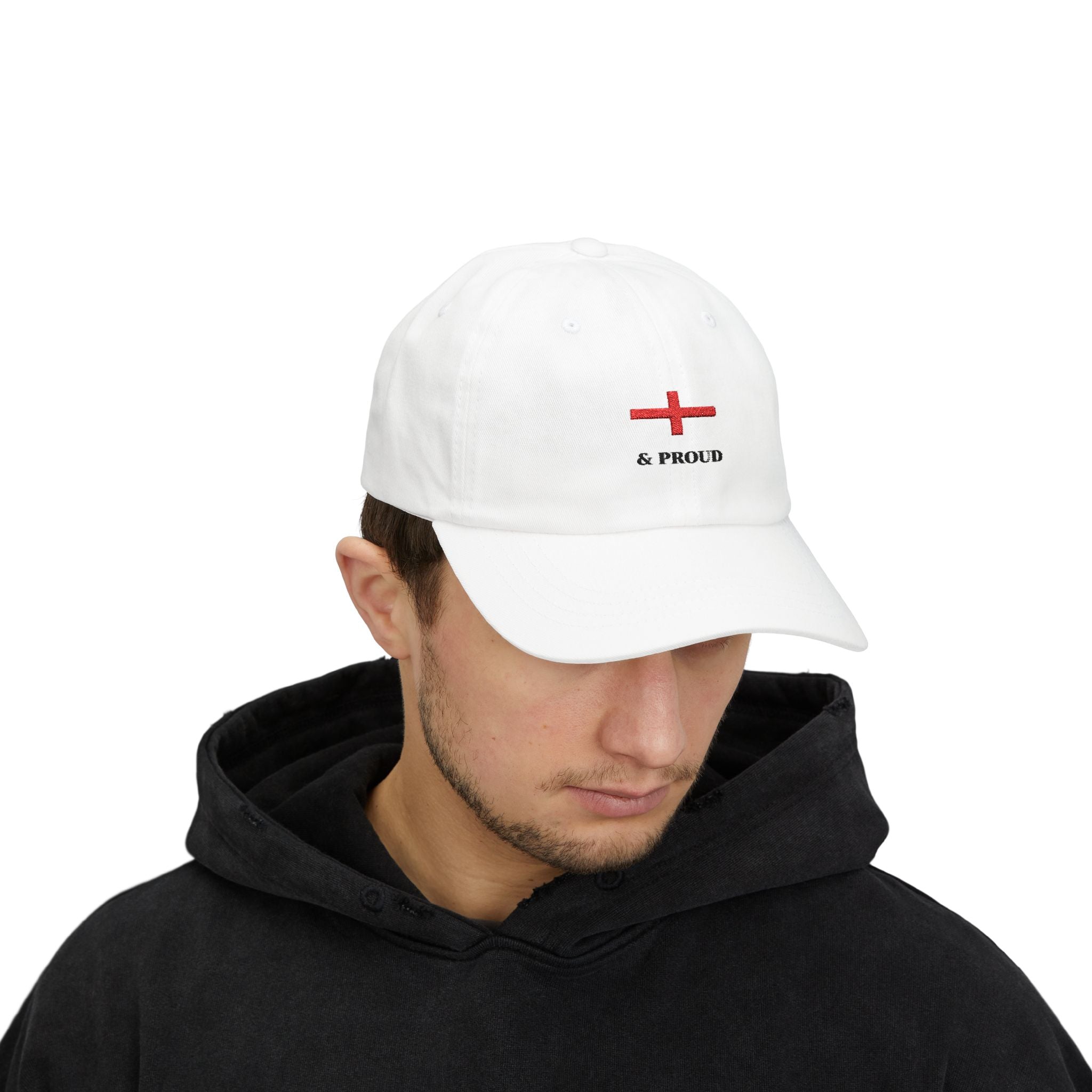 Person wearing a white cap with a red  St Georges Cross to form English Flag and black "& Proud" writing.